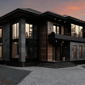 Modern two-story house with large windows, dark wood, and stone elements, under a sunset sky. The driveway leads to the entrance, conveying elegance and warmth.